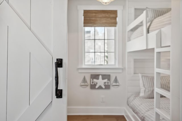 interior space with baseboards and wood finished floors