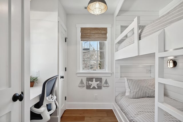 interior space featuring baseboards and wood finished floors