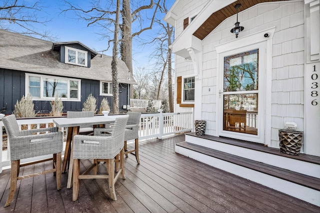 wooden terrace with outdoor dining space