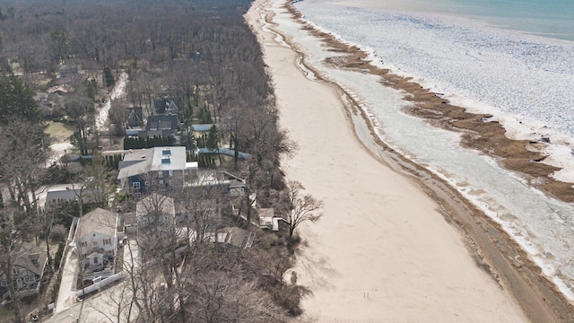 drone / aerial view featuring a water view and a view of the beach