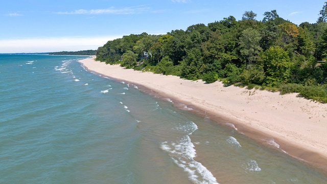 drone / aerial view featuring a beach view and a water view