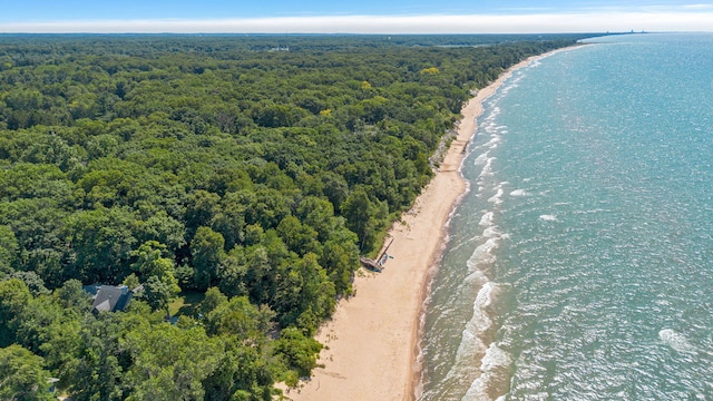 birds eye view of property featuring a beach view, a forest view, and a water view