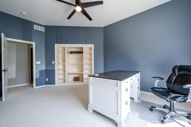 office featuring visible vents, baseboards, light carpet, and ceiling fan