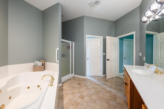 bathroom with vanity, a shower stall, baseboards, and a whirlpool tub