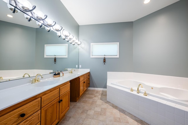 full bath featuring a sink, recessed lighting, a bath, and double vanity