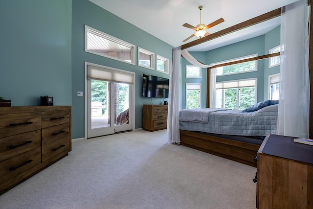 bedroom with multiple windows, carpet floors, a high ceiling, and ceiling fan