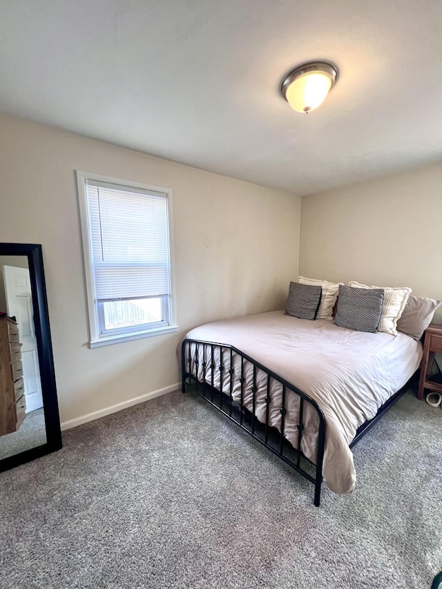 carpeted bedroom featuring baseboards