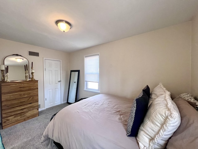 carpeted bedroom with baseboards and visible vents