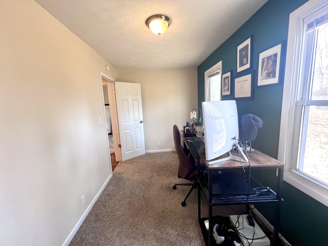 office area featuring baseboards, carpet floors, and a textured ceiling