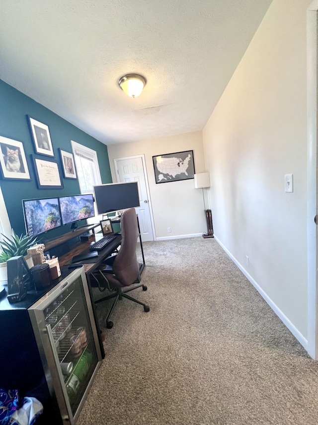 home office featuring baseboards, carpet, and a textured ceiling