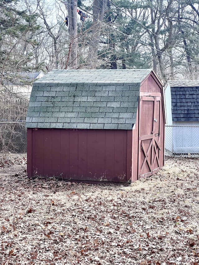 view of shed with fence