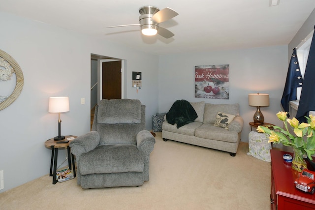 living room featuring visible vents, carpet floors, and a ceiling fan