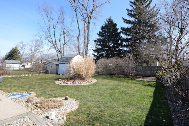 view of yard with an outdoor structure and a fenced backyard