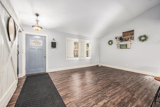 entrance foyer with vaulted ceiling, baseboards, dark wood-type flooring, and visible vents