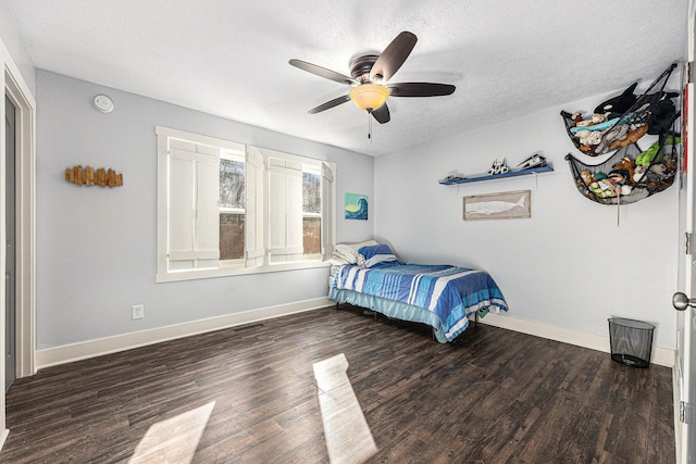 bedroom featuring a textured ceiling, wood finished floors, visible vents, and baseboards