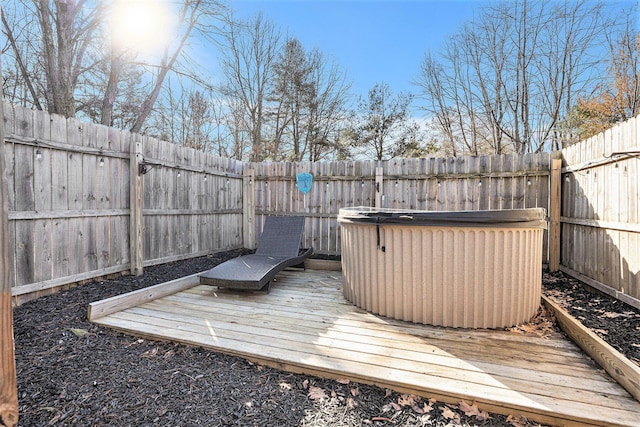 wooden deck with a fenced backyard