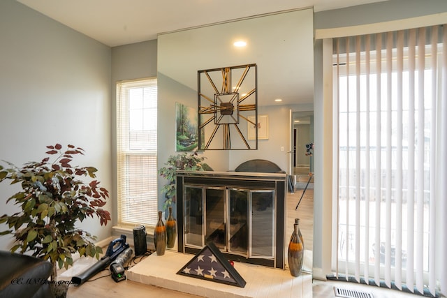 living room featuring a notable chandelier, wood finished floors, and visible vents