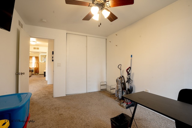 office featuring visible vents, ceiling fan, and carpet flooring