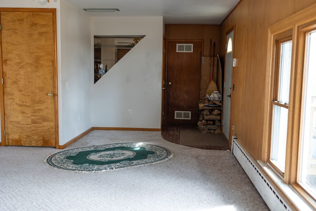 foyer with visible vents, plenty of natural light, and a baseboard radiator