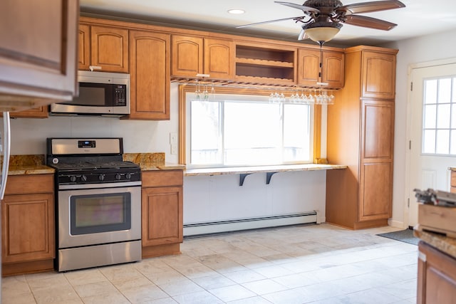 kitchen with light stone countertops, brown cabinets, appliances with stainless steel finishes, and a baseboard radiator