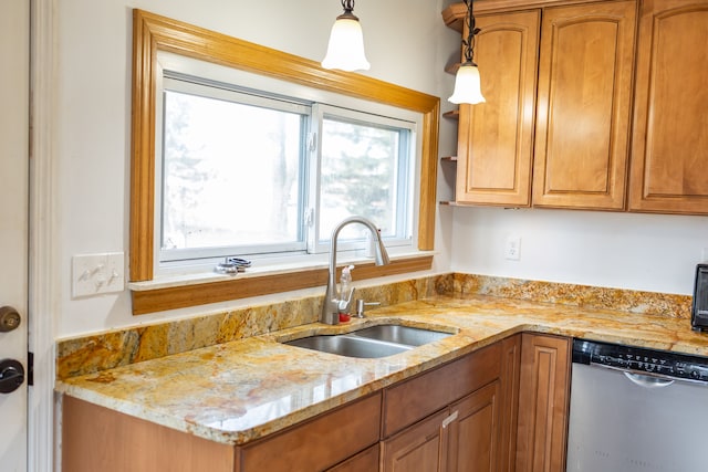 kitchen with a sink, stainless steel dishwasher, brown cabinetry, light stone countertops, and hanging light fixtures