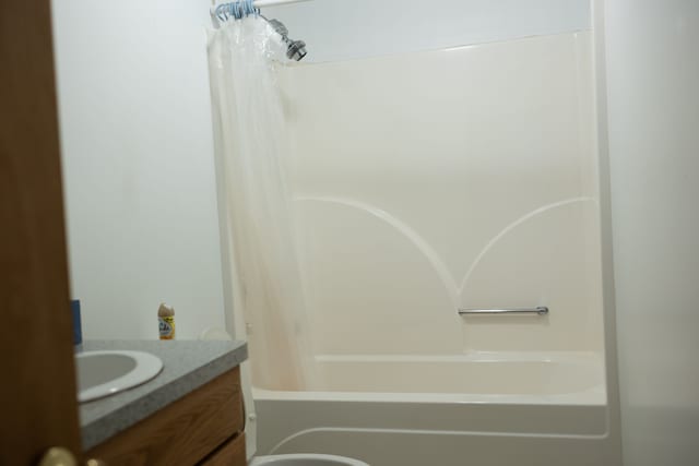 bathroom featuring vanity and shower / bath combination with curtain