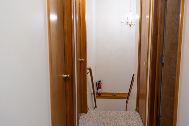 corridor featuring a notable chandelier