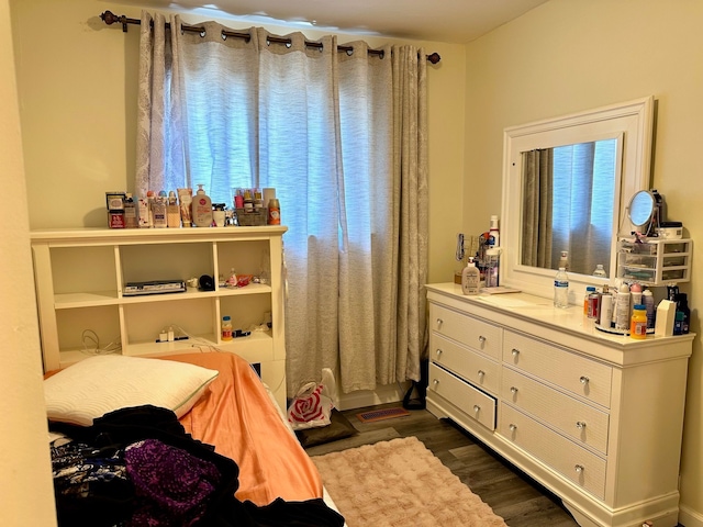 bedroom featuring dark wood-style flooring