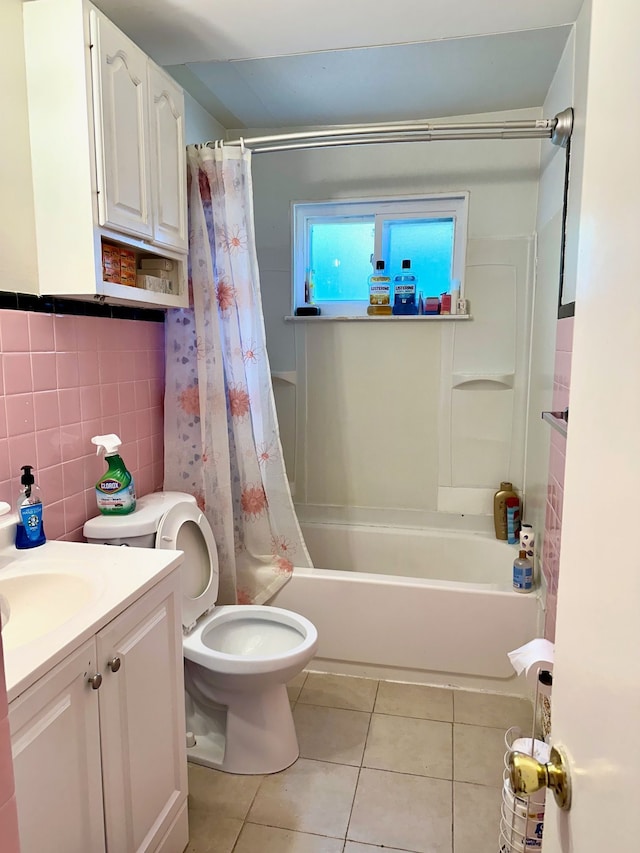 full bath with vanity, tile patterned flooring, shower / tub combo, tile walls, and toilet