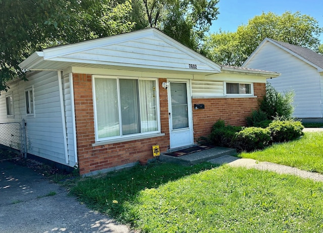 bungalow-style home with brick siding