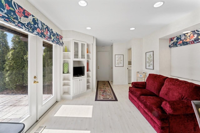 living area featuring recessed lighting, french doors, visible vents, and light wood finished floors