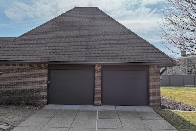 garage with fence and driveway