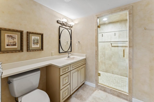 bathroom with vanity, baseboards, a stall shower, tile patterned flooring, and toilet