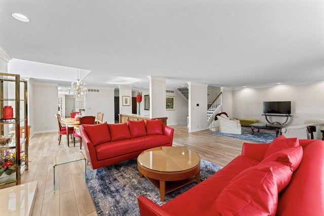 living area with crown molding, stairway, and light wood finished floors