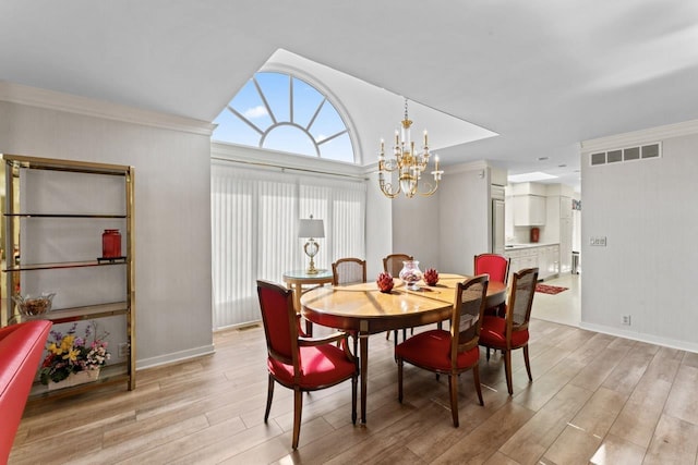 dining area featuring light wood finished floors, visible vents, an inviting chandelier, and lofted ceiling