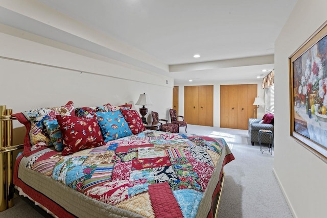 bedroom with recessed lighting, baseboards, multiple closets, and carpet flooring