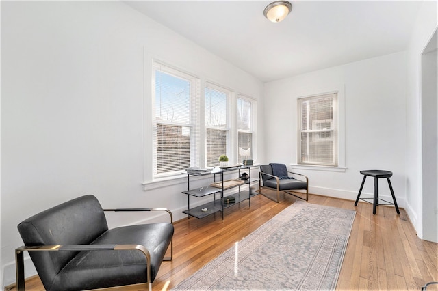 sitting room featuring baseboards and hardwood / wood-style floors