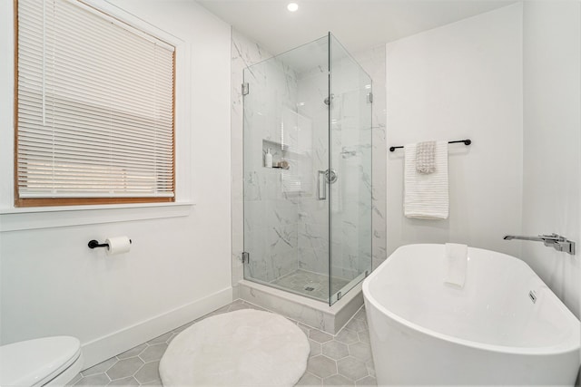 full bath with a soaking tub, toilet, baseboards, and a marble finish shower