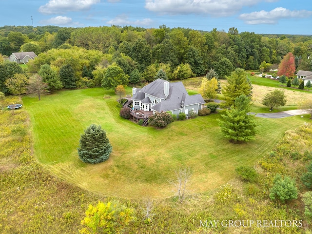 drone / aerial view featuring a forest view