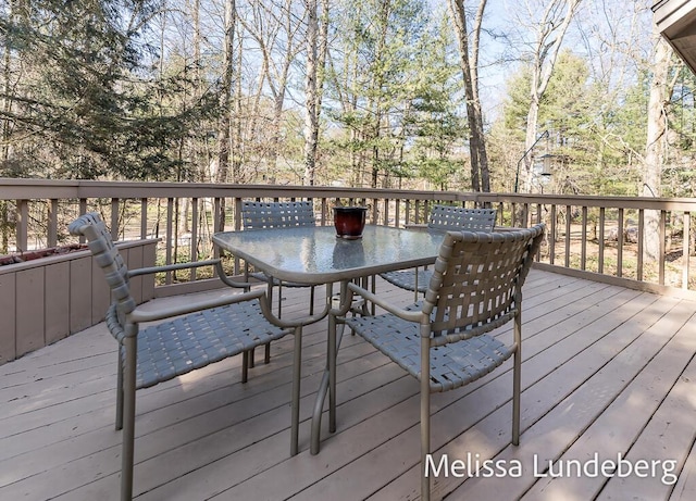 wooden terrace with outdoor dining space