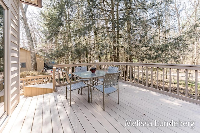 wooden terrace with outdoor dining area