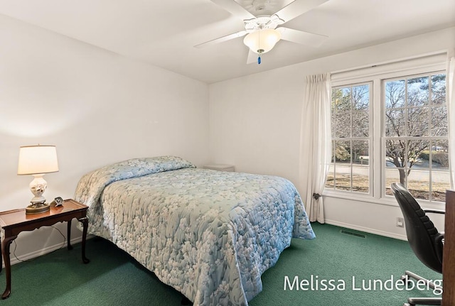 carpeted bedroom featuring baseboards, visible vents, and ceiling fan