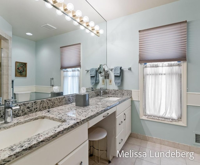 full bathroom with tile patterned floors, visible vents, double vanity, and a sink