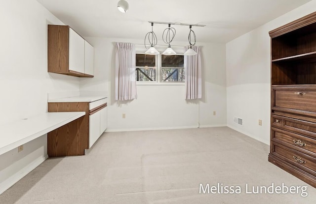 dining room with baseboards, visible vents, and light carpet