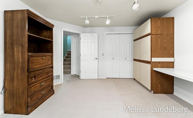 walk in closet featuring visible vents and light colored carpet