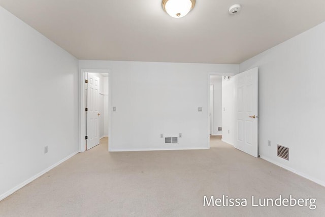 carpeted empty room with baseboards and visible vents