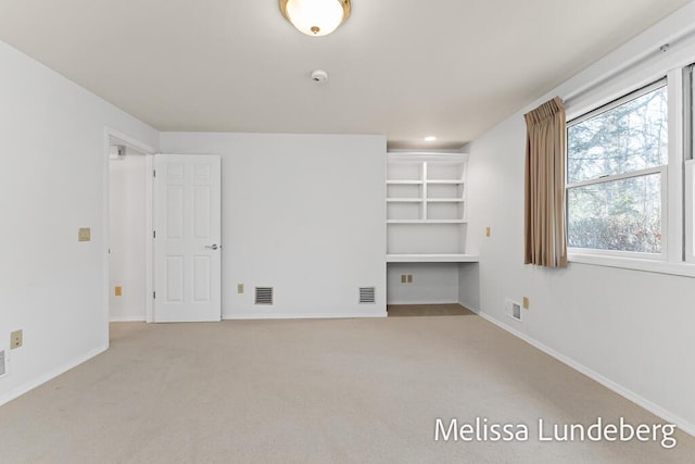 carpeted spare room with recessed lighting, baseboards, and visible vents