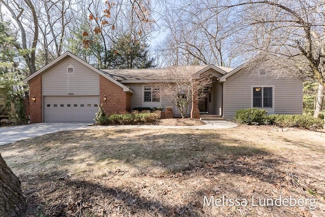 ranch-style home with brick siding, driveway, and a garage