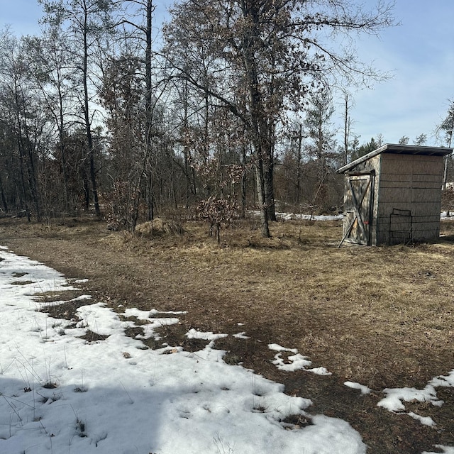 snowy yard with an outbuilding