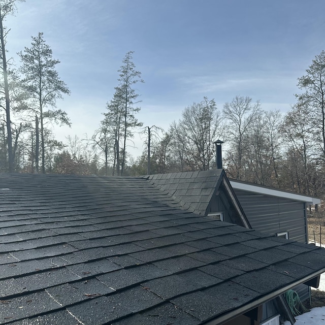 exterior details with a shingled roof